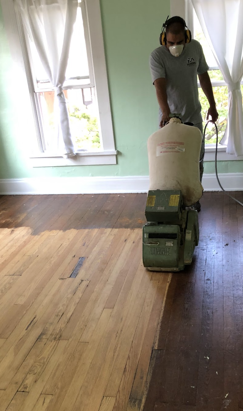 a fabulous floors technician refinishing a hardwood floor